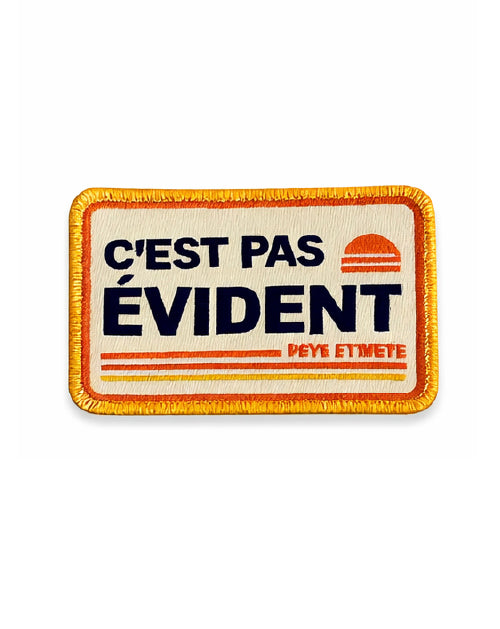 Écusson brodé "C'est Pas Évident"
